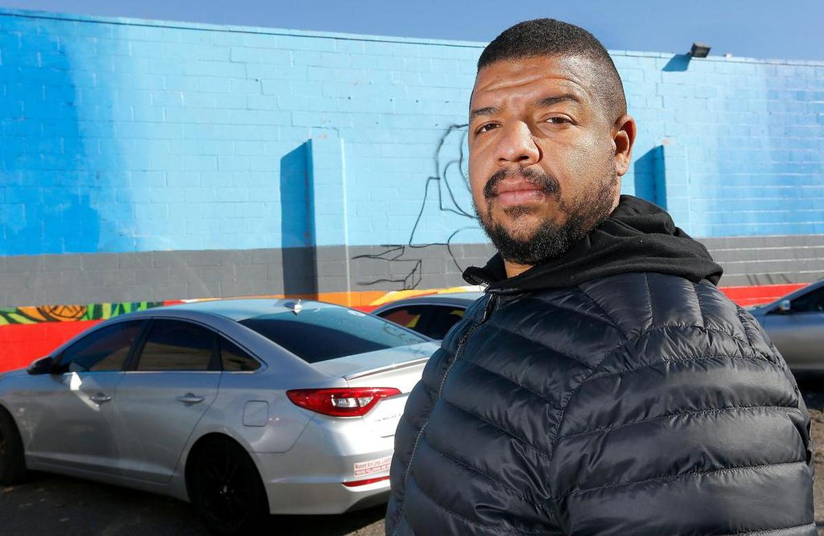 In this file photo from 2019, Jordan Chaney, organizer of the Community Hope Wall, stands next to a nearly completed mural on the side of Vinny’s Bakery in Pasco. He was appointed this year to a state task force on racial injustice and policing.