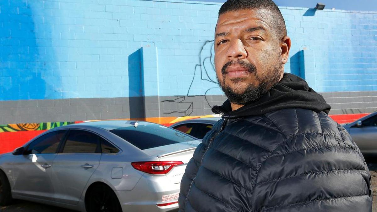 In this file photo from 2019, Jordan Chaney, organizer of the Community Hope Wall, stands next to a nearly completed mural on the side of Vinny's Bakery in Pasco. He has been appointed to a state task force on racial injustice and policing.