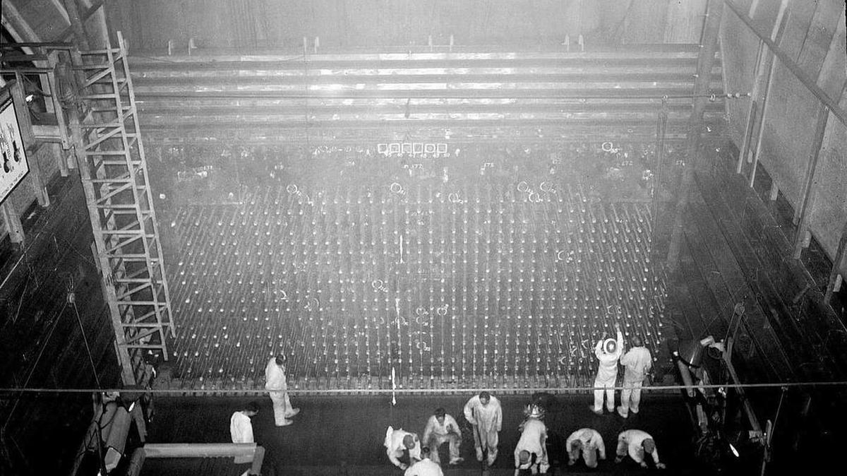 Hanford workers perform tasks in 1944 at the front face of B Reactor, the world’s first full-scale nuclear reactor.