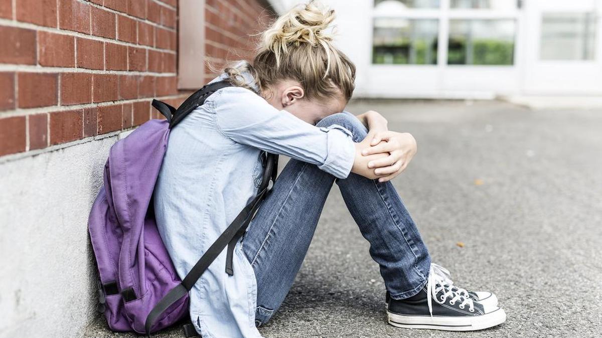 A unhappy pre-teen girl at school