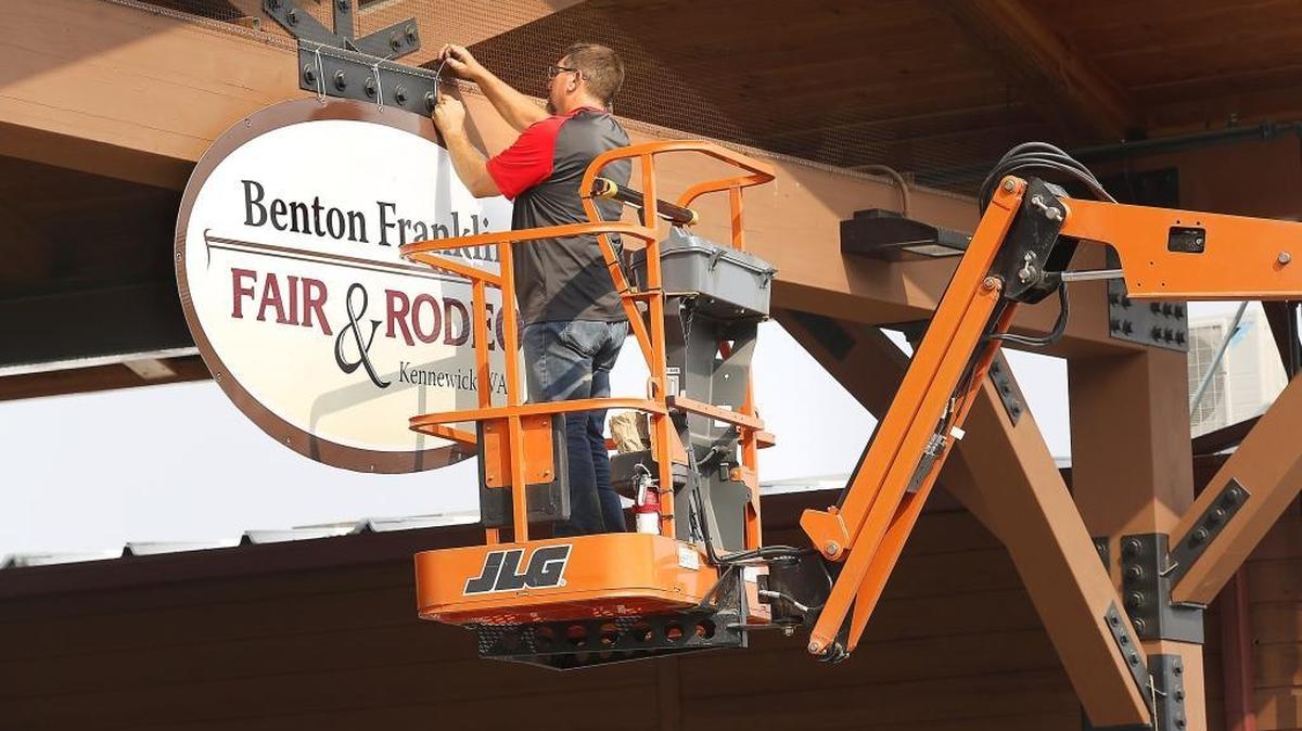 Fair board member Brian Goulet volunteers Thursday placing signs around the Benton County Fairgrounds in preparation for next week’s 70th annual Benton Franklin Fair & Rodeo in Kennewick. The fair opens on August 21.