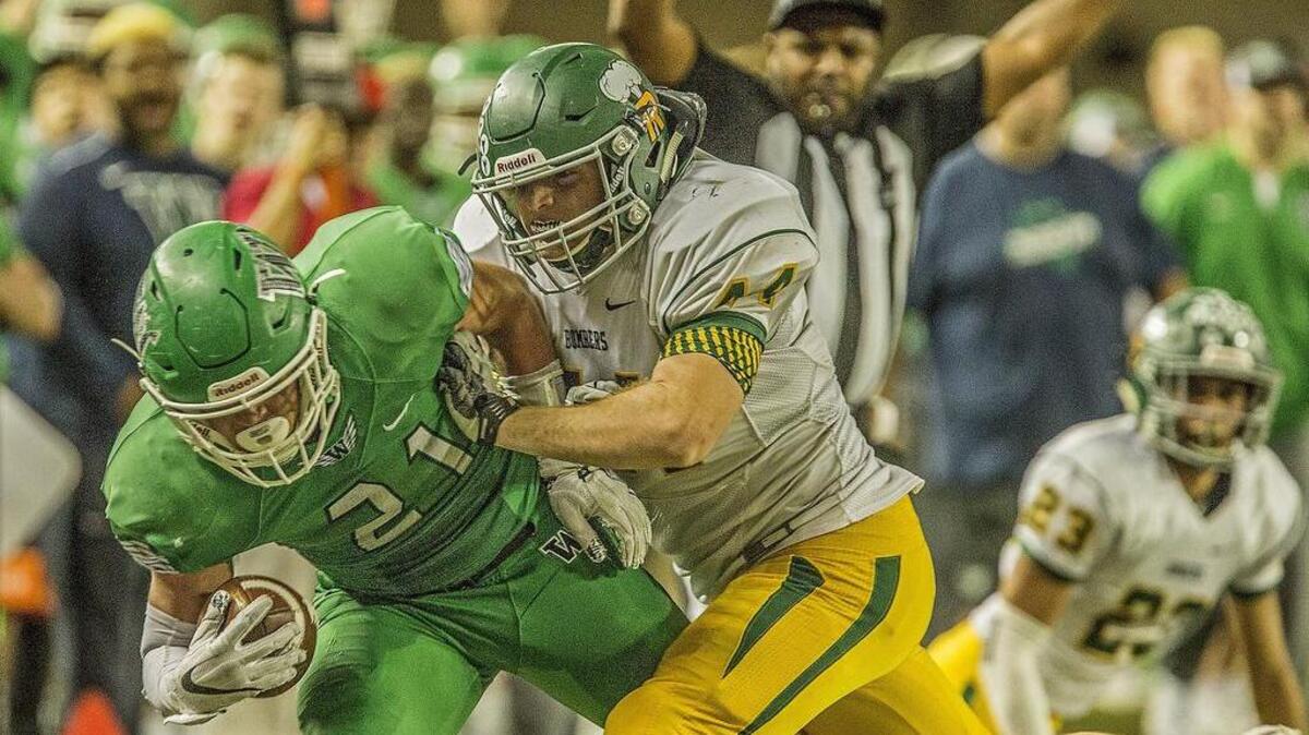 Woodinville wide receiver Brett Accimus (21) is pushed out of bounds after a long reception in the Woodinville Falcons and Richland Bombers 4A Washington state football championship game in the Tacoma Dome Saturday, Dec. 2, 2017.