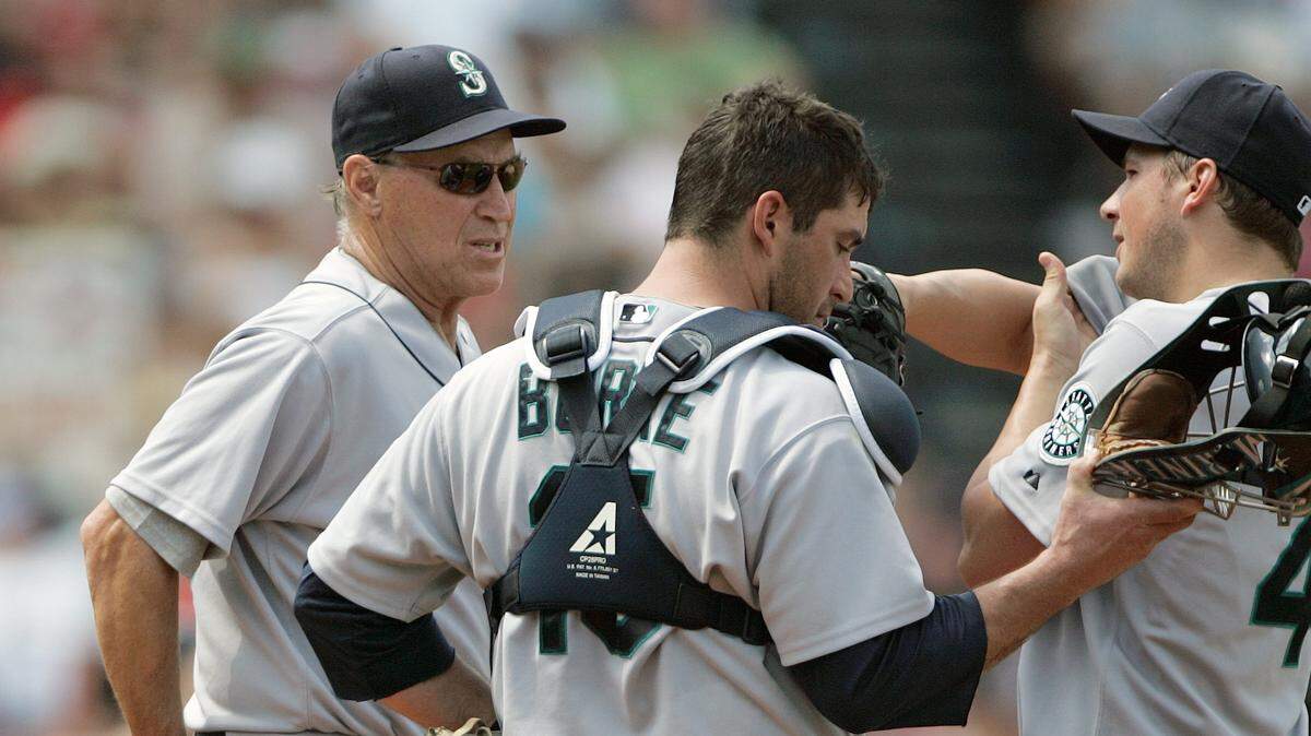 The Seattle Mariners pitching coach Mel Stottlemyre, left, makes a visit to the mound with catcher Jamie Burke, center, as starting pitcher Erik Bedard wipes his brow with the bases loaded in the third inning of a baseball game against the Boston Red Sox, Sunday, June 8, 2008, in Boston. The Red Sox forced one run when Bedard hit the Red Sox’s J.D. Drew with a pitch. (AP Photo/Michael Dwyer) ORG XMIT: MAMD104