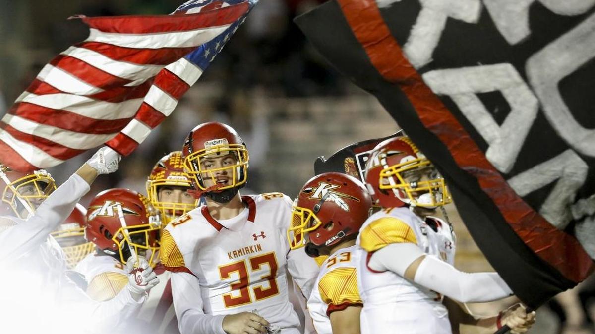 Kamiakin’s football team runs out on to the field after the national anthem at Fran Rish Stadium on Friday before the start of a Mid-Columbia Conference football game against Richland. The Braves were mistakenly told the anthem would be played later than it was, and reaction from fans was immediate.