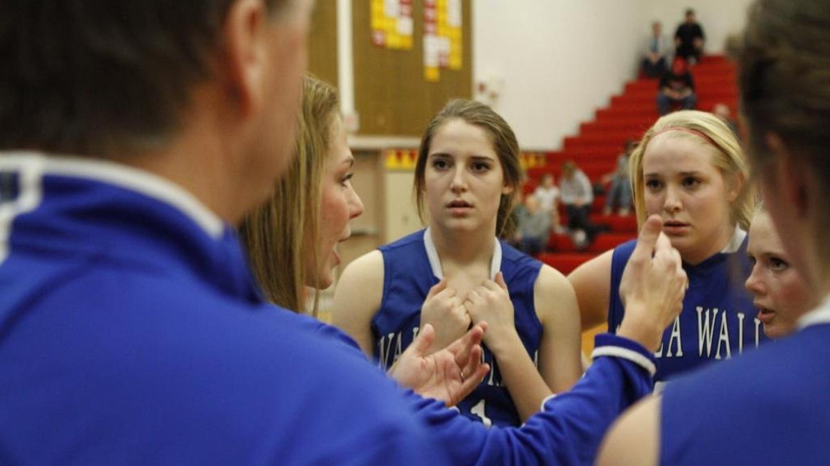 Mikayla Ferenz, center, and twin sister Kate Ferenz listen to former Walla Walla girls basketball coach Jill Meliah during a 2014-15 MCC game. Now a junior on the Idaho women’s team, Mikayla was named to the Academic All-America first team on Monday, becoming just the second Vandal woman to earn the honor.