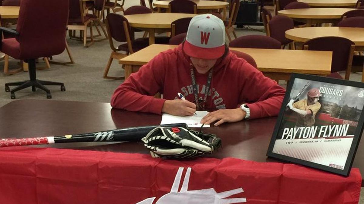 Kamiakin High School senior Payton Flynn signs a letter of intent Wednesday to play baseball for Washington State.