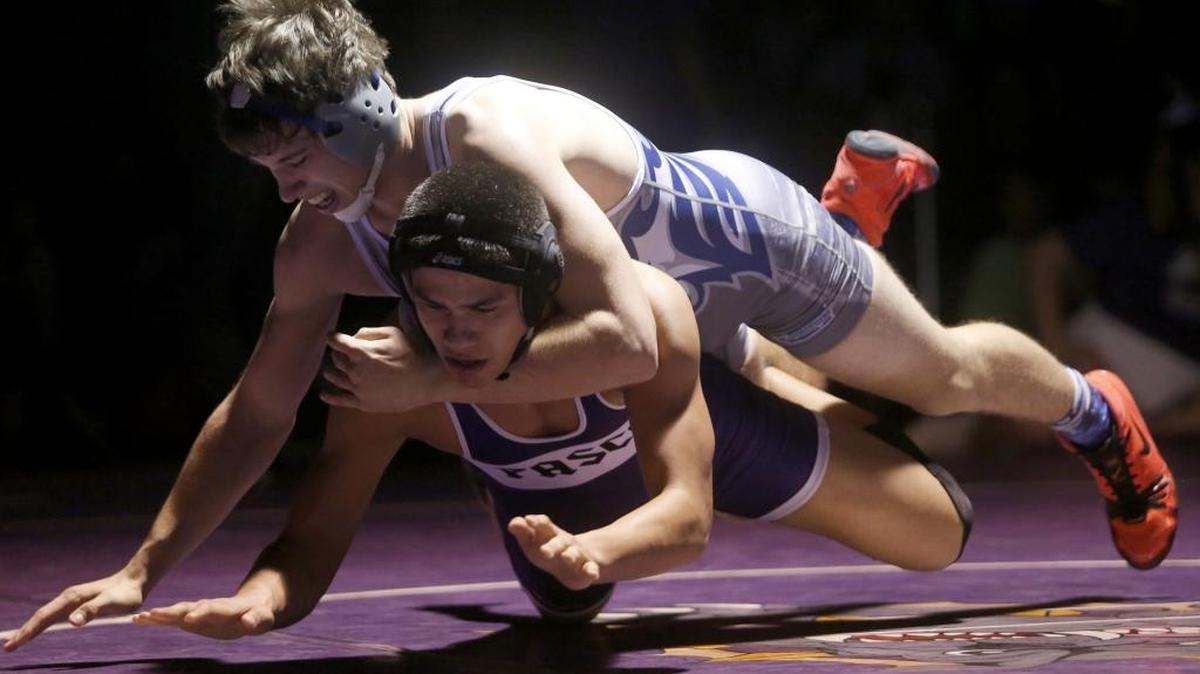 Chiawana’s Cory Johnson, top, has the advantage as he and Pasco’s Justin Ochoa hit the mat during their 160-pound match Friday night at Pasco High School. The wrestling dual was part of a tripleheader with girls and boys basketball.