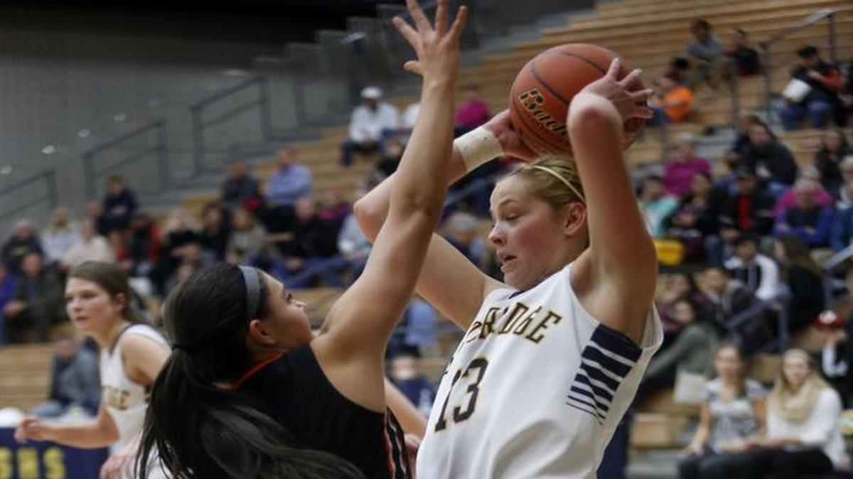 Ellie Smith (13), of host Southridge High School, attempts to pass over Kennewick’s Hannah Templeton on Tuesday night.