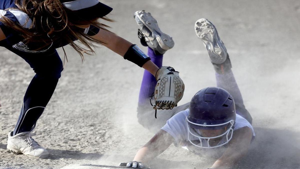 Pasco’s Adriana McKinney dives back safely into first base under the tag by Chiawana’s Kami Bengen during Thursday’s softball game at Chiawana High School.