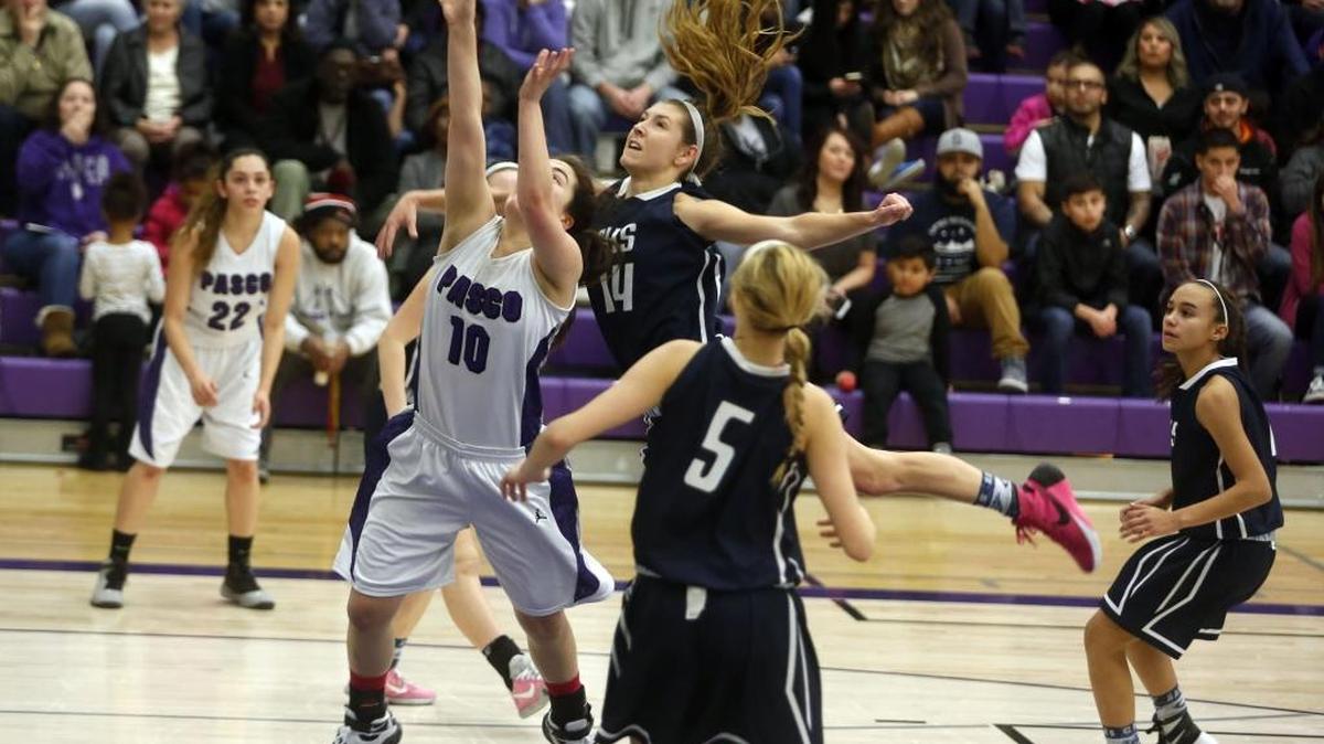 Chiawana High School’s Braydey Hodgins (14) blocks a shot by Pasco’s Bella Gutierrez (10) on the Bulldogs’ court Friday night.