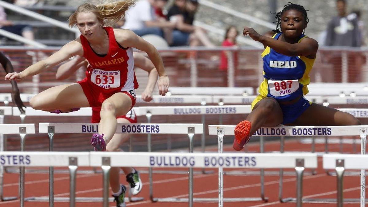 Kamiakin High School’s Heather Donais is just ahead of Mead’s Zella Conley in the girls 100-meter hurdles Saturday during the 55th annual Pasco Track and Field Invitational at Edgar Brown Memorial Stadium. Donais beat Conley, the defending champion, by two-hundredths of a second.
