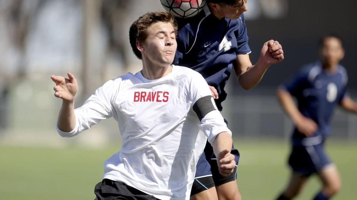 Chiawana High School’s Jose Lucatero (4) and Kamiakin High School’s Muamer Ibisevic (front) head a ball Saturday during a boys soccer game at Neil F. Lampson Stadium in Kennewick. See more photos at www.tricityherald.com.
