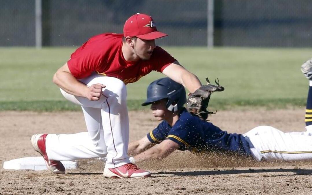 Kamiakin High School’s Logan Smith, left, attempts to get the out against Southridge’s Jake Harvey during Tuesday’s Mid-Columbia Conference doubleheader at Southridge High School. The Suns won both games.