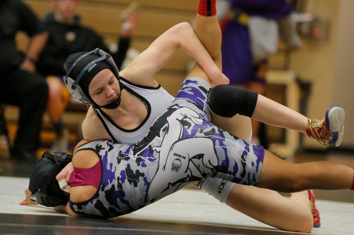 Hanford’s Taylor Wilson, top, wrestles with Cynthia Cisneros of Pasco in a 106-pound bout girls wrestling match on Thursday at Hanford High School in Richland. Hanford’s Wilson won by pin.