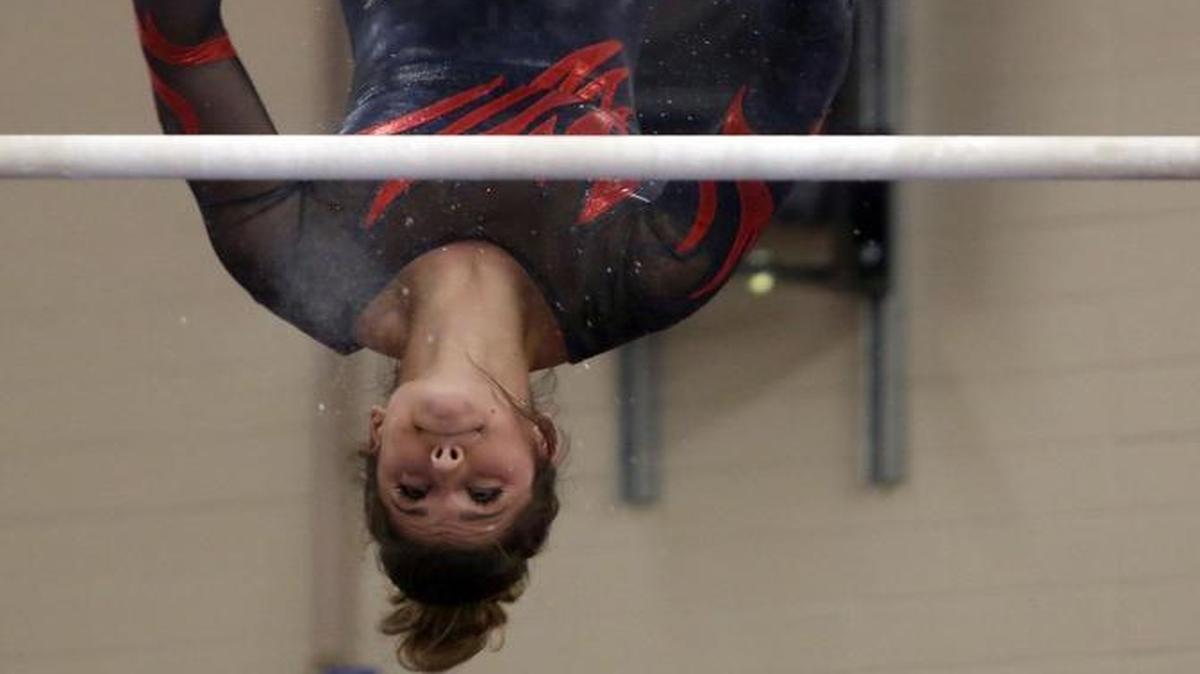 Kamiakin High School’s Saige Polanik dismounts from the bars Wednesday during the regular-season finale against visiting Southridge. Polanik won the all-around, and the Braves took the meet.