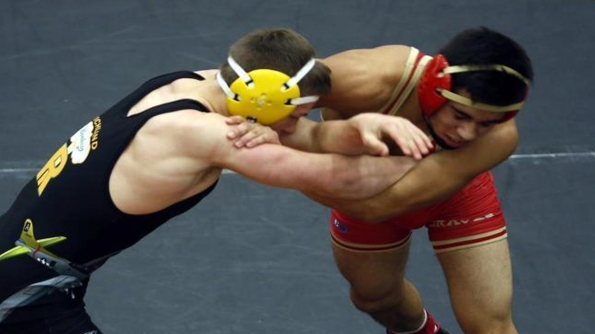 Richland’s Patrick Workman wrestles Kamiakin’s Franky Garcia in the 145-pound semifinals Saturday at the Bob Mars Tournament at Kennewick High School.