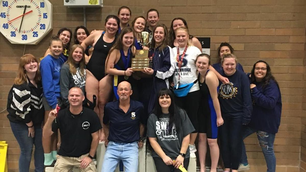 The Southridge Suns swim team poses with their district trophy after winning the team title Saturday in Kelso.