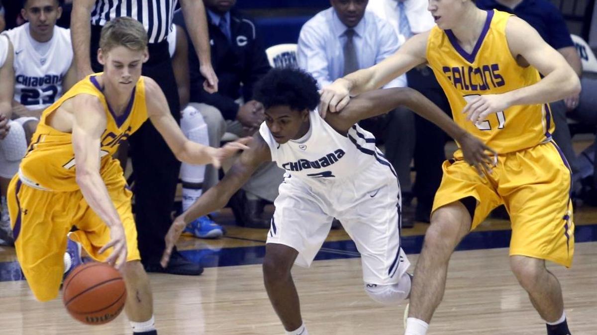 Hanford High School’s Will Eldred (10) steals the ball from Chiawana’s Malik Taylor (3) as the Falcons’ Conner Sutey defends during a December game in Pasco.