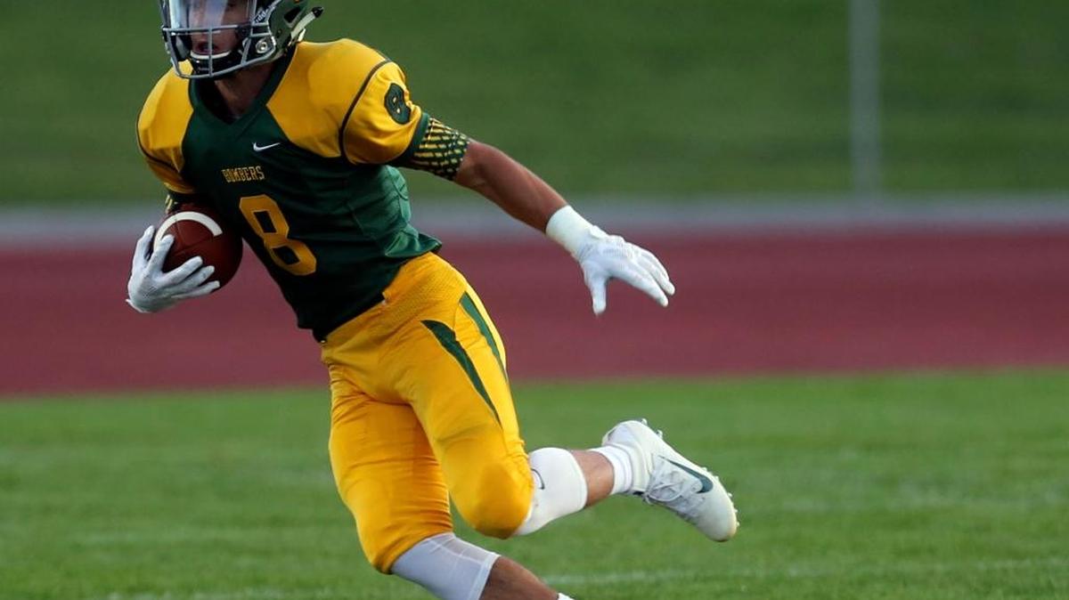 Richland’s senior wide receiver Alex Chapman runs with the ball against Skyline Friday at Fran Rish Stadium. Chapman caught two touchdown passes and had an interception.