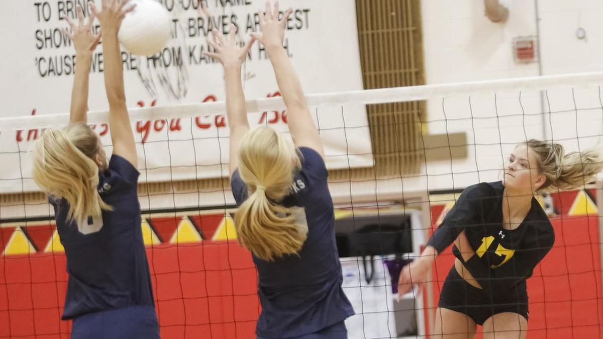 Kamiakin's Delaney Frame (17) spikes a ball against Chiawana’s defense in an MCC game Oct. 10. After going 3-11 in MCC play, the Braves are one now win away from a state berth and bi-district title as they play at Mt. Spokane at noon Saturday in the MCC-GSL 3A championship game.