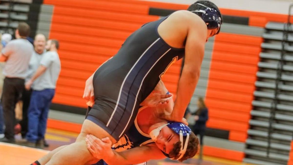 Kiona-Benton’s Alejandro Llerenas (on knees) wrestles Wapato’s Juan Vidrio in a 195-pound semifinal match during the Bob Mars Tournament on Saturday at Kennewick High School. Llerenas won by pin, and went on to win the title.