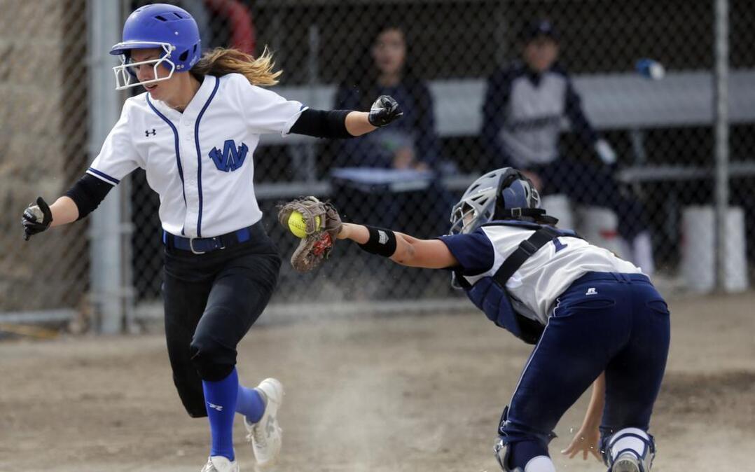Walla Walla High School's Kamryn Coleman, diving out of the way of Chiawana High School's Morgan Hirai to score a run during the 2016 season, is the Tri-City Herald’s 2017 All-Area Softball Player of the Year. The junior pitched 157 innings for the Blue Devils, going 22-3 with a 1.29 ERA.