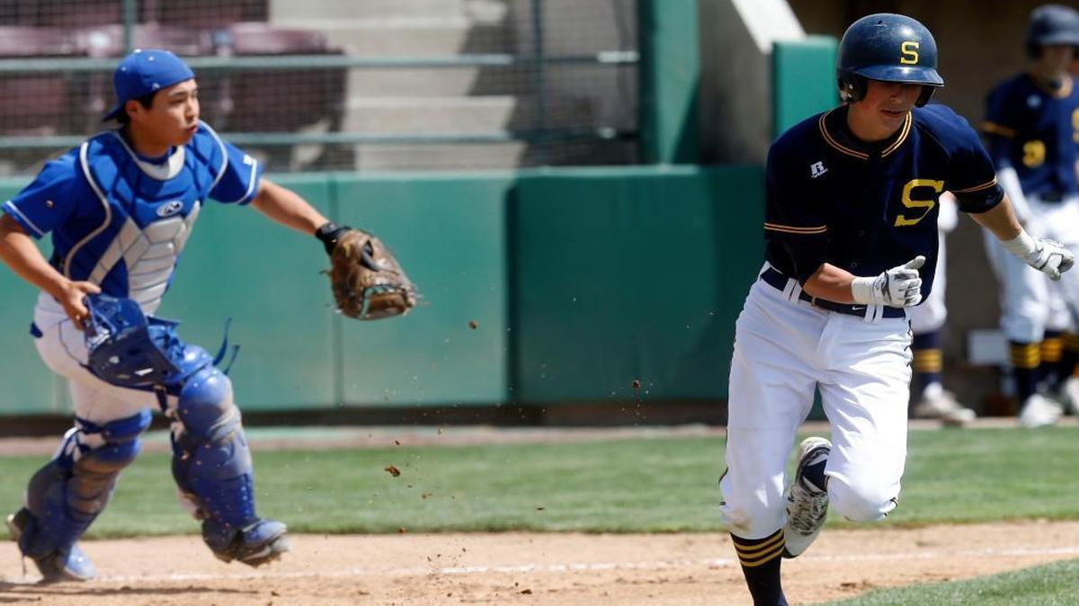 Southridge’s Jake Harvey heads down the first-base line as Walla Walla catcher Futa Ikuma fields the ball during Saturday’s game at Gesa Stadium, part of the Mid-Columbia Baseball Classic.