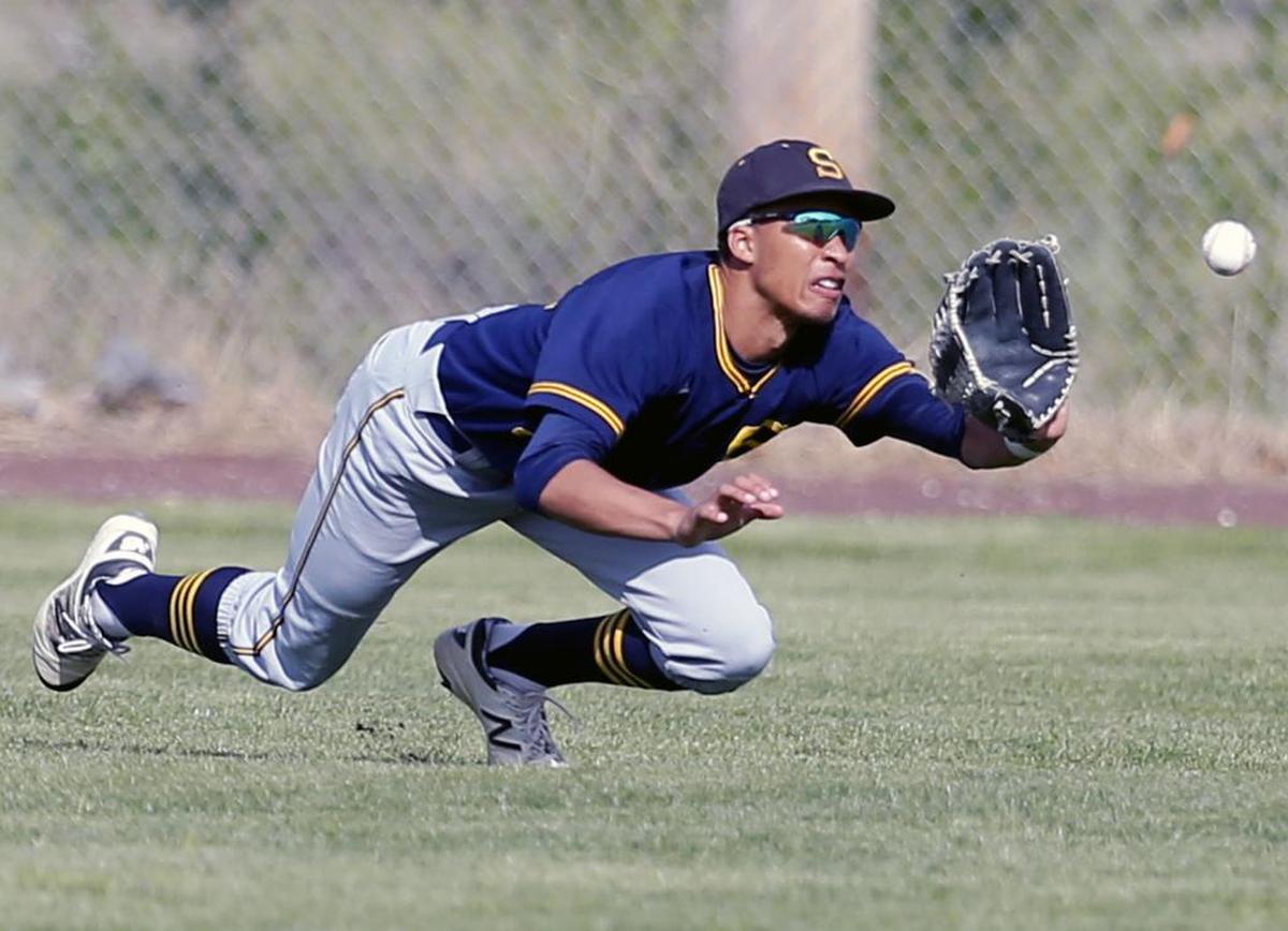Southridge High School’s Jashaun Simon dives for a ball in the outfield during a game against Richland High School in this file photo.