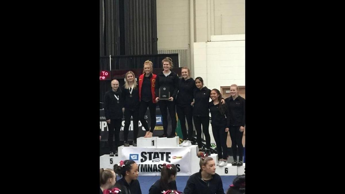 The Kamiakin gymnastics team poses after taking second in the WIAA state 1A/2A/3A/ gymnastics championships on Thursday at the Tacoma Dome Exhibition Hall.