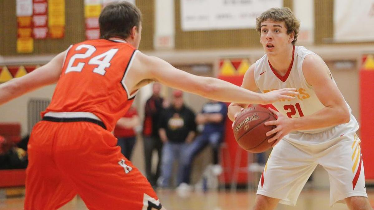 Kamiakin’s Champ Grayson (21), staring down Kennewick’s Tyler Pearson (24) during their game on Friday, scored 24 points on Saturday to lead the Braves to a key road win over Walla Walla. It was his third straight game scoring more than 20 points.