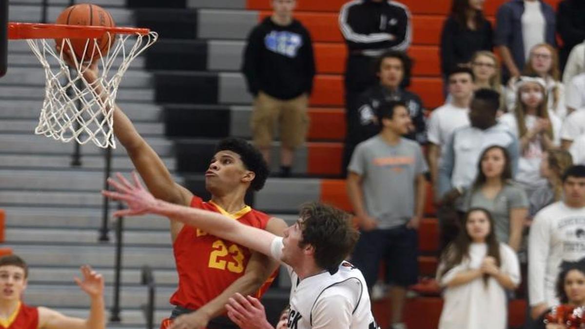 Kamiakin’s Isaiah Brimmer (23) puts up a shot over Kennewick’s Samuel Szendre (32) during Saturday’s MCC/GSL subregional game at Kennewick High School.