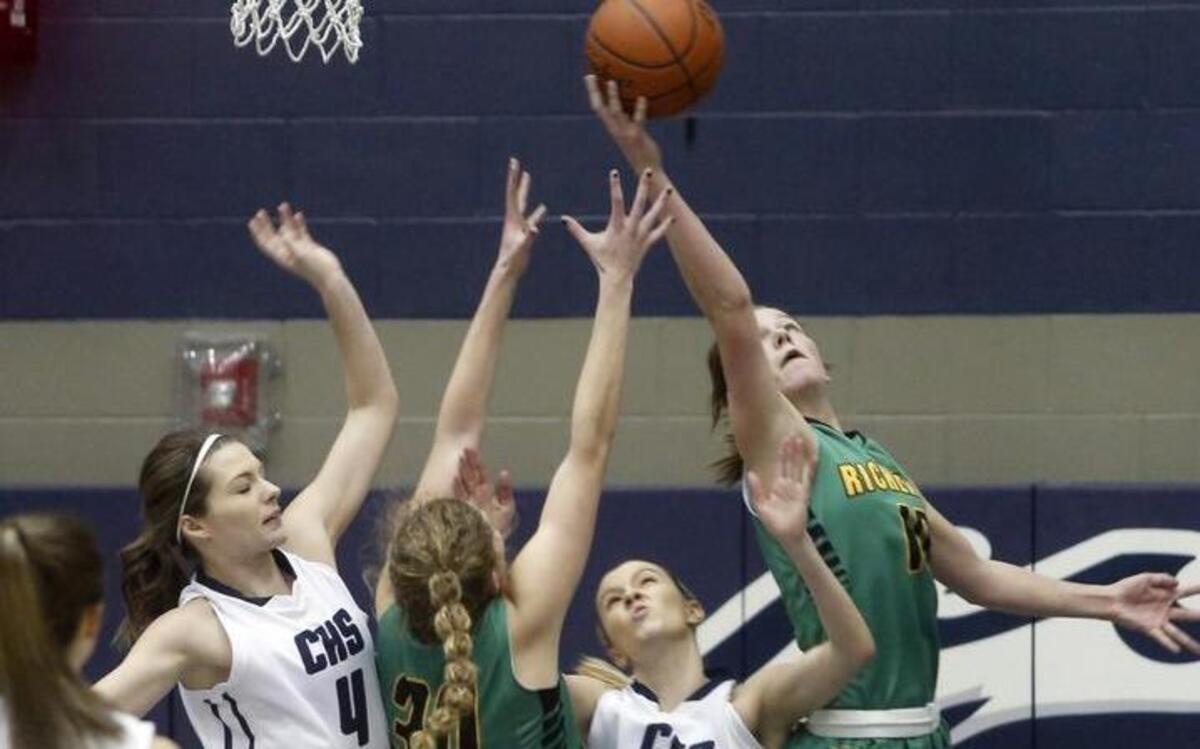 Chiawana High School’s Kenedy Cartwright (5) and Sarah Haertling (4) reach for a rebound alongside Richland’s Mickala Trappett (10) and Maysun Wellsandt (30) during Saturday night’s Class 4A subregional elimination game at Chiawana. See more photos at www.tricityherald.com.