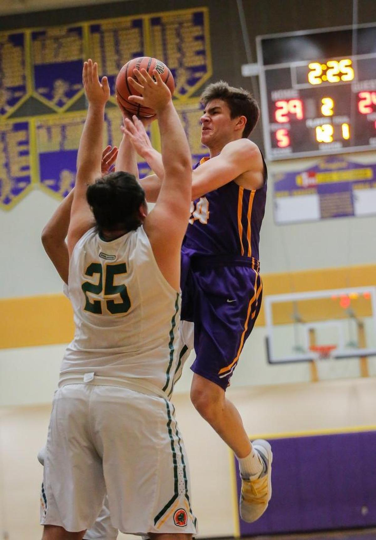 Shadle Park's Luke Krotzer (25) guards Hanford's Dan Izquierdo (24) as he takes a shot during a boys basketball game Thursday at Hanford High School in Richland. Izquierdo scored a game-high 19 points to lead the Falcons to a 68-59 victory.