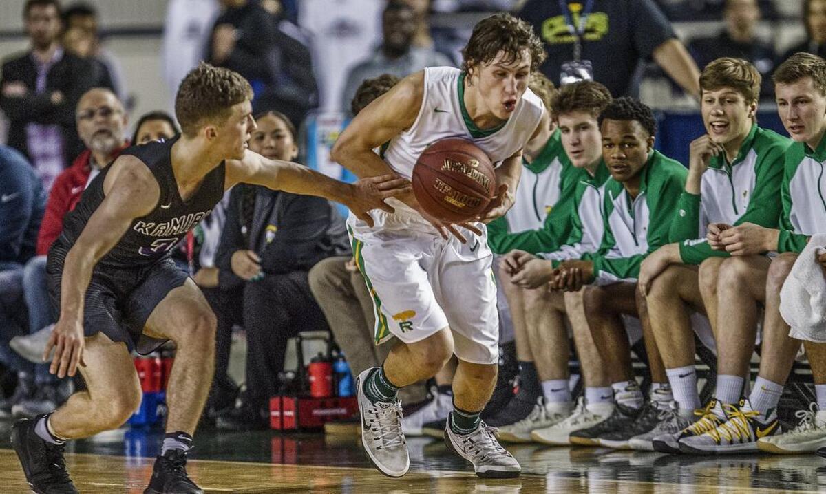 Richland guard Cole Northrop, right, heads up the court after picking the ball from Kamiak guard Carson Tuttle during the Richland vs. Kamiak state quarterfinal game at the Tacoma Dome on March 1. Richland won 72-42.