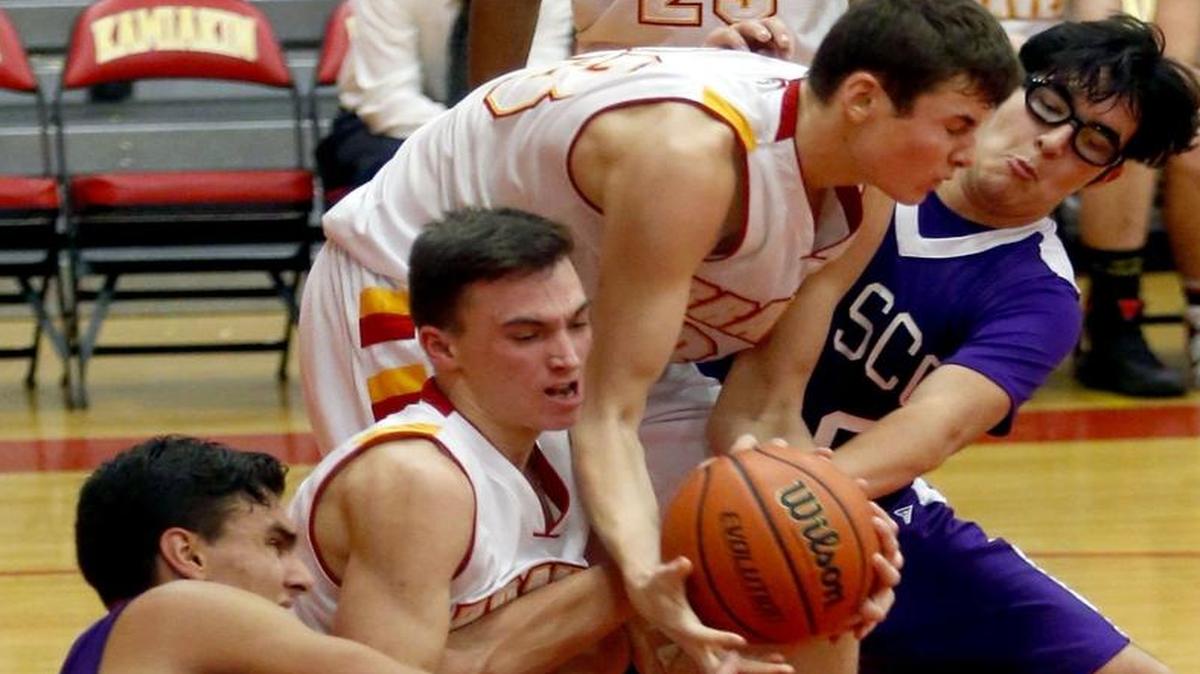 Pasco’s Sebastian Gutierrez, left, and Diego Gutierrez battle Kamiakin’s Garrett Paxton, second from left, and Hayden Nelson for a loose ball during Friday’s Mid-Columbia Conference basketball game at Kamiakin High School. For all Friday’s results, see pages 6B and 7B. See more photos at www.tricity herald.com.