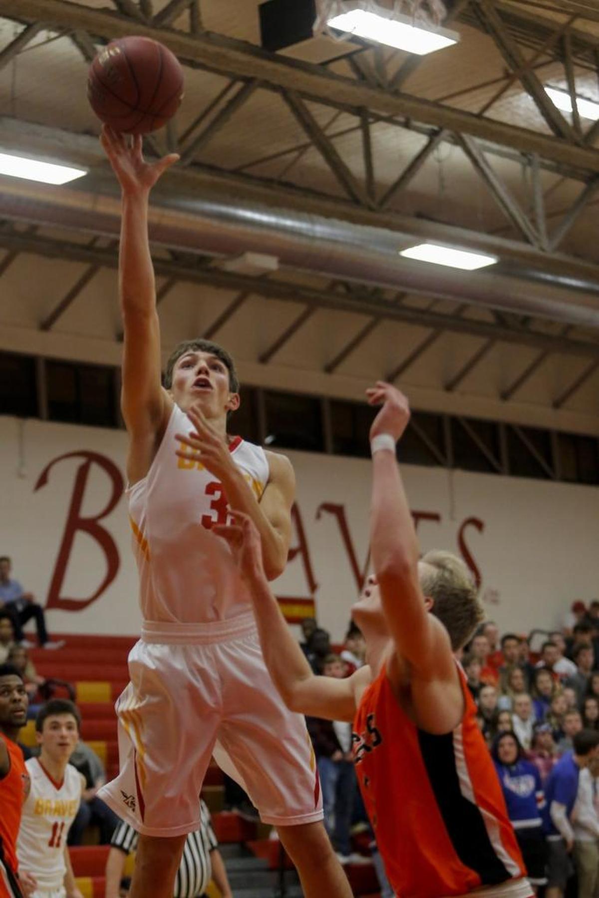Kamiakin’s Robert Pischel (35) shoots the ball while being guarded by Lewis and Clark’s Griffin Effenberger (5) during a boys basketball game Saturday in Kennewick.