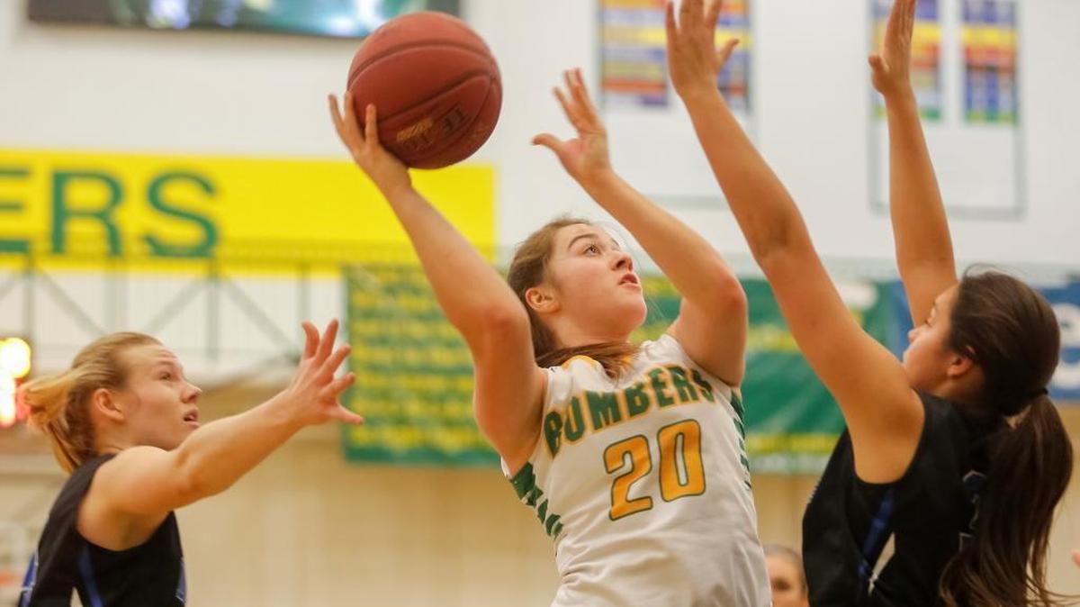 Richland's Halee Pierce (20) attempts to shoot over the Walla Walla defense during an MCC girls basketball game Friday at Richland High School. The Bombers beat the Blue Devils 59-56.