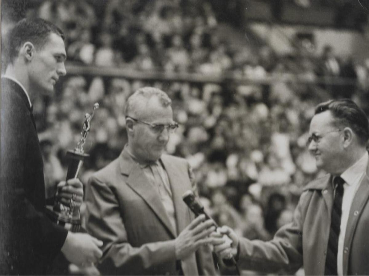Jim House, right, and Richland basketball coach Art Dawald accept the third-place trophy at the 1963 state basketball tournament.