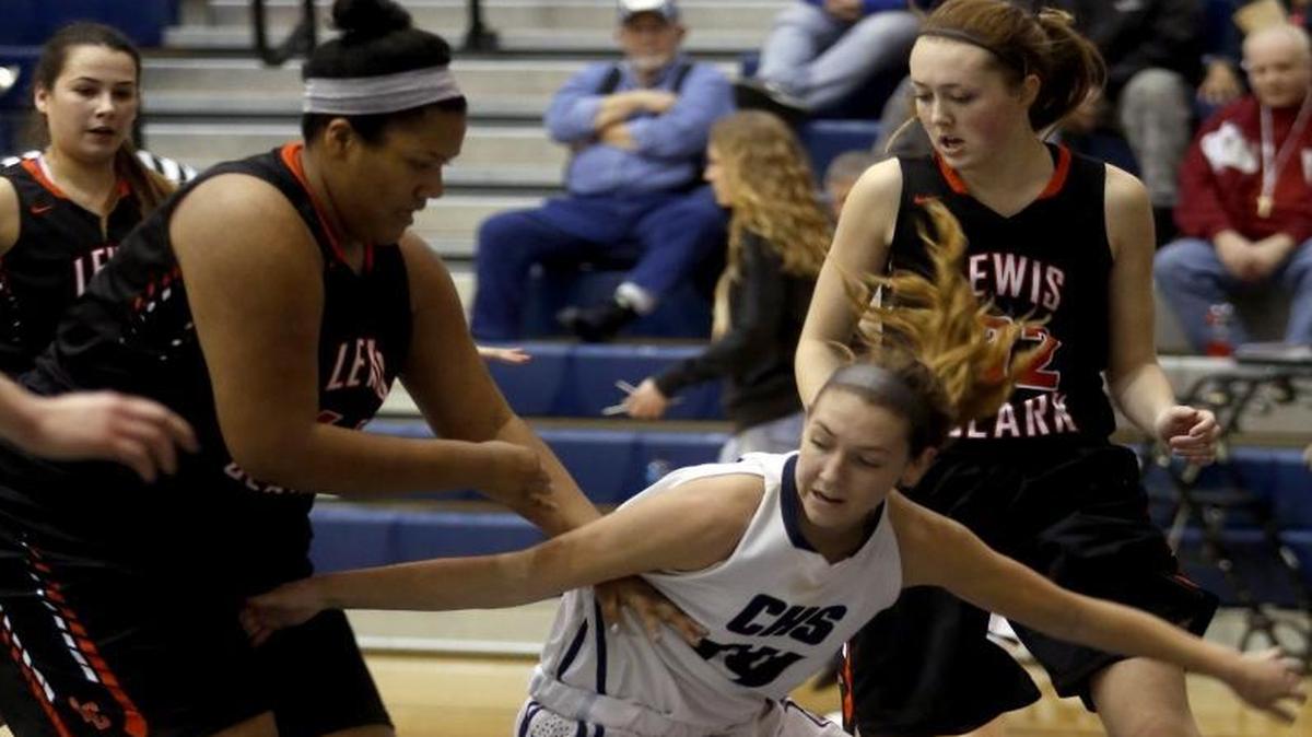 Chiawana’s Braydey Hodgins (14) runs into a lot of traffic among Lewis & Clark’s Claire Mann (44) and Taylor Cunningham (32) during Friday’s subregional game at Chiawana High School.