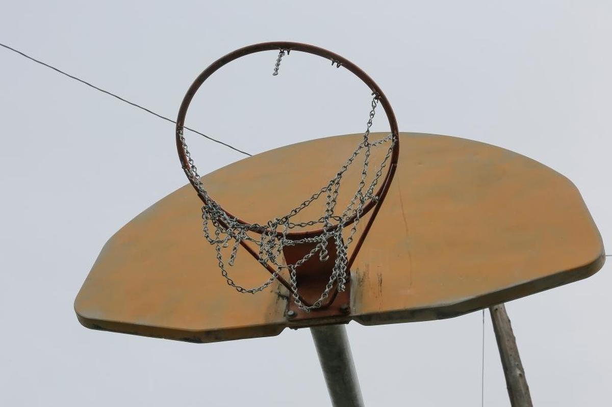 A rundown basketball hoop with a partial chain net is what greets players at Columbia Playfield in Richland.