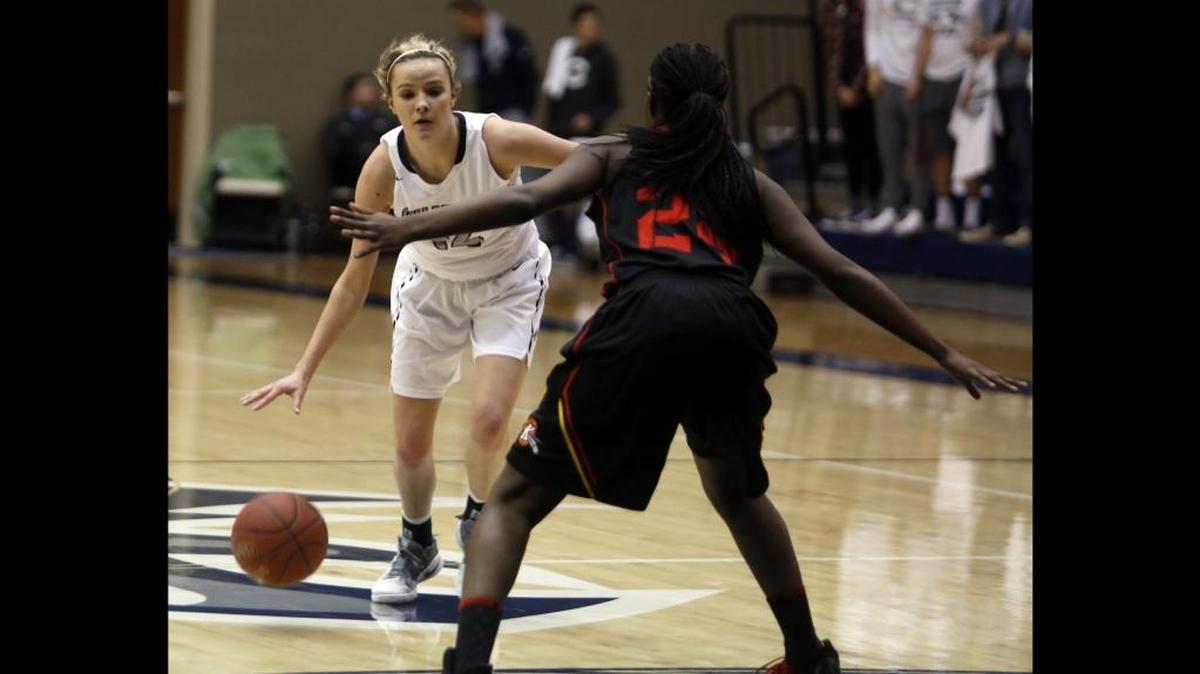Chiawana’s Kenedy Cartwright, trying to dribble past Kamiakin’s Oumou Toure during an MCC girls basketball game earlier this season, scored 18 points in the Riverhawks’ loser-out district playoff win over Richland on Tuesday.