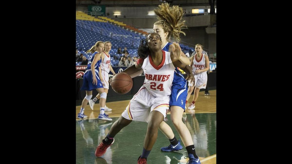 Kamiakin’s Oumou Toure (24) drives past Seattle Prep’s S.J. Bracket during a consolation game of the 2017 3A WIAA girls state basketball tournament at the Tacoma Dome. A bill in the state senate would require all high school state basketball championships feature 16 teams per classification, per gender at the state tournament site. Currently, 12 teams compete at each tournament.