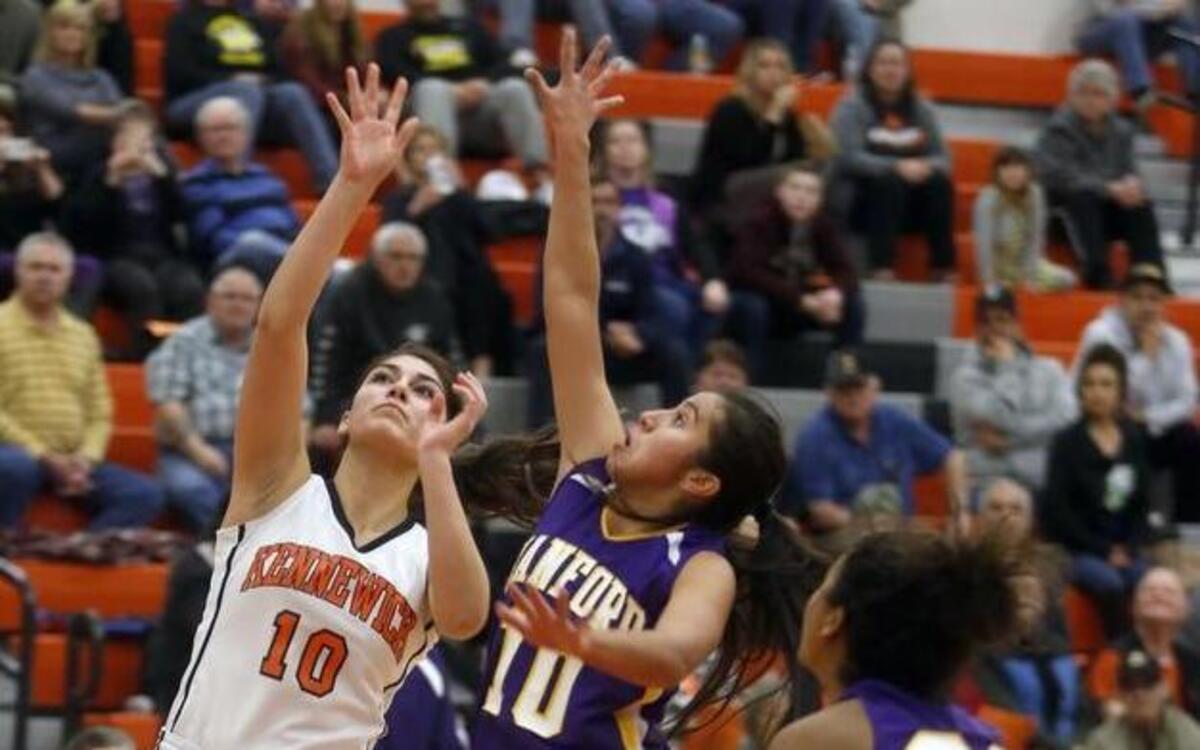 Kennewick’s Klarissa Barajas, left, takes a shot over Hanford’s Dani Mendoza during Tuesday’s Mid-Columbia Confernce 3A district elimination game at Kennewick High.