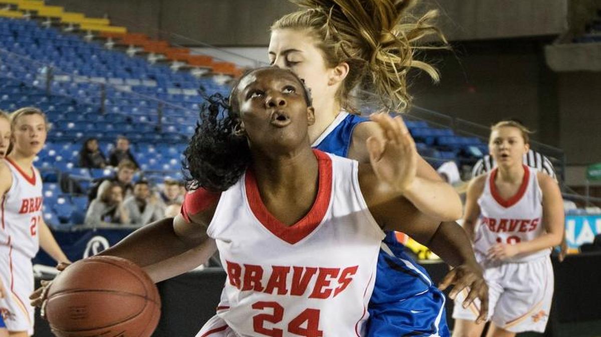 Kamiakin’s Oumou Toure (24) looks to get off a shot with Seattle Prep’s S.J. Brackett on her back during Friday’s consolation game at the 3A girls basketball state tournament in Tacoma.