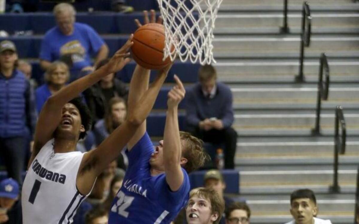 Chiawana High School’s Jalen King (1) attempts a shot against Walla Walla’s Andrew Harvey (32) on Saturday night in Pasco. King had eight points, 17 rebounds and five blocks, but Wa-Hi won 56-45.