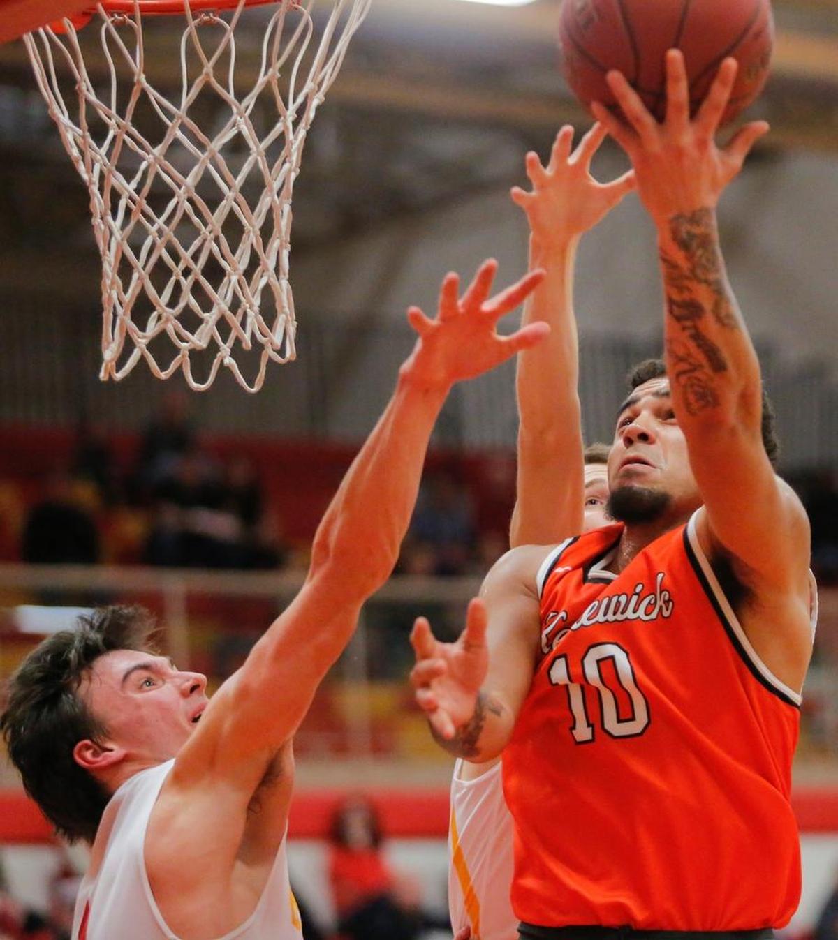 Kennewick's Martavis Higgins (10) takes a shot over Kamiakin’s Champ Grayson during a Mid-Columbia Conference boys basketball game Friday at Kamiakin High School.
