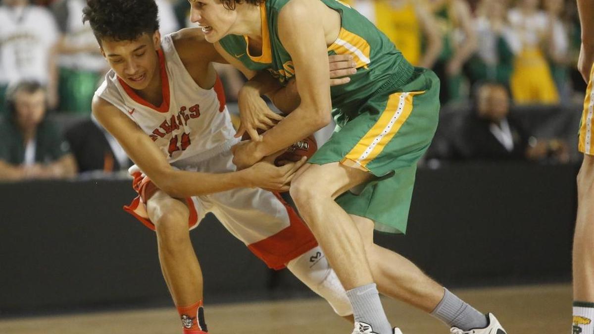 Davis' Alex Guerrero (11) fights for possession with Richland's Cole Northrop (24) in the fourth quarter. Richland played Davis in a basketball game at the Tacoma Dome in Tacoma on Wednesday.