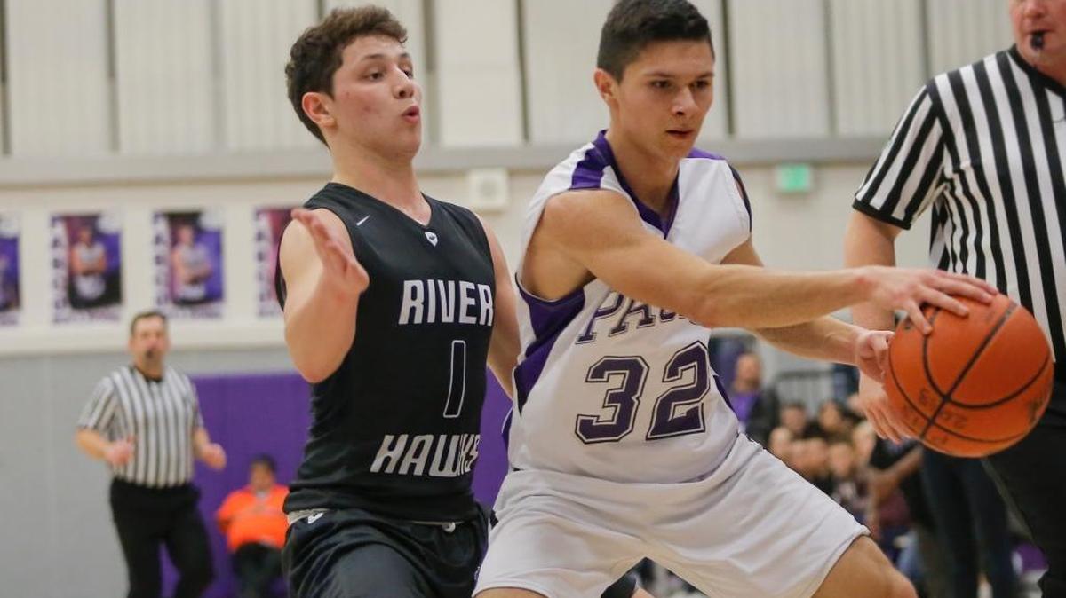 Chiawana’s Austin Penny (1) guards Pasco’s Moises Cuevas (32) as he dribbles the ball during a Mid-Columbia Conference basketball game Saturday at Pasco High School. Penny scored 20 points to match his career benchmark and lead Chiawana to a 67-56 victory.