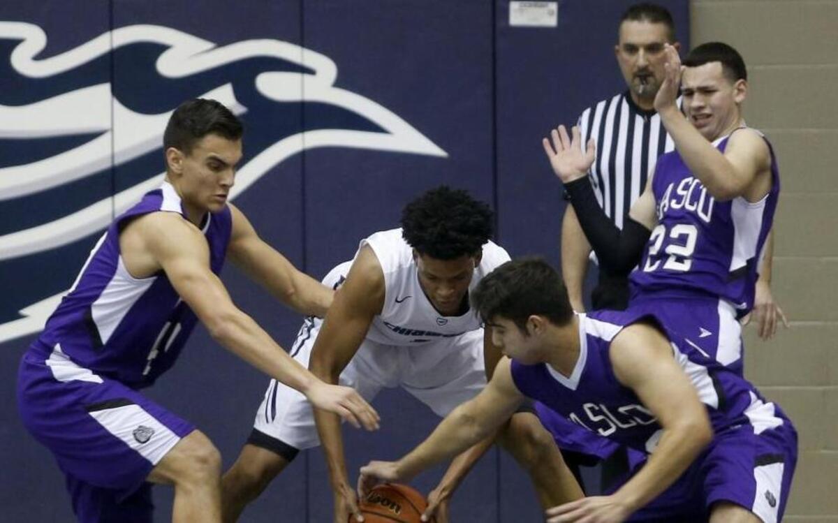Chiawana’s Jalen King, center, fights for a loose ball with Pasco’s Emilo Davila, lower right, and Sebastian Gutierrez, left, during Friday’s Mid-Columbia Conference game at Chiawana High School.