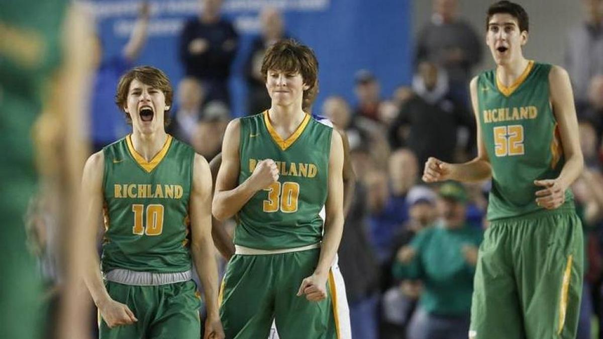 Richland's Cody Sanderson (10), Garrett Streufert (30), and Riley Sorn (52) react during their state playoff game against Federal Way last season. The Bombers beat the Eagles 61-57.